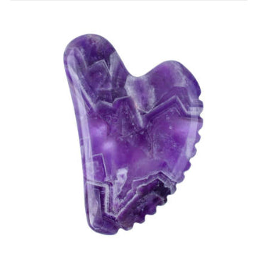 Heart-shaped purple stone gua sha with a ridged edge