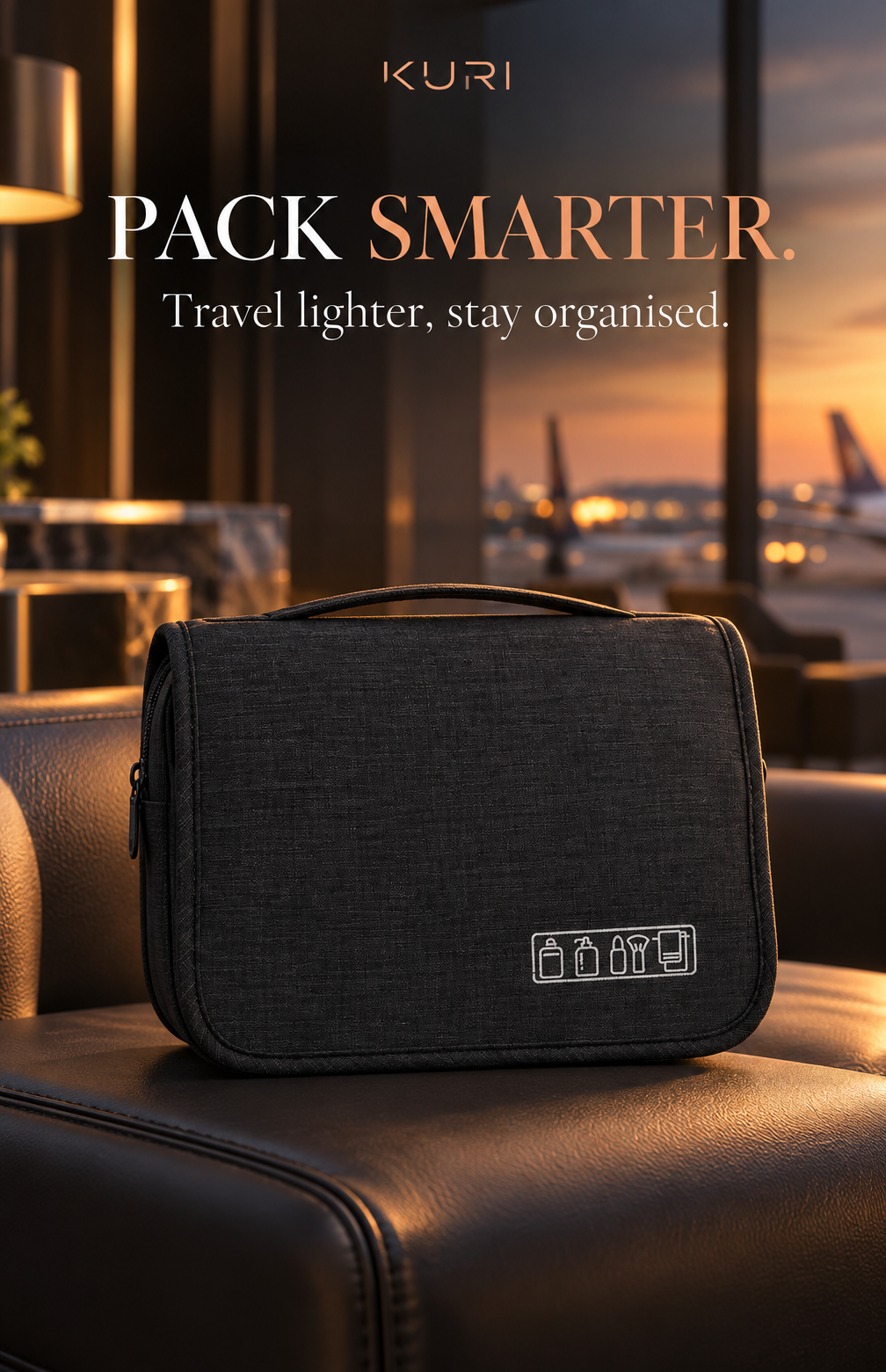 Black hanging travel toiletry bag folded closed with a carry handle, shown in an airport lounge