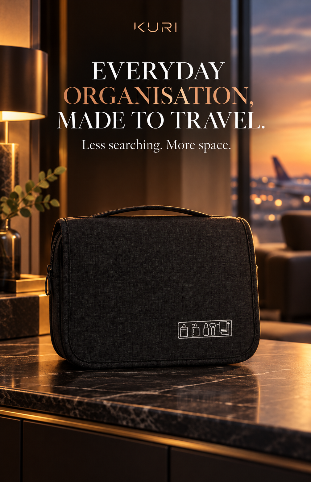 Black hanging travel toiletry bag with a top carry handle shown on a bathroom counter